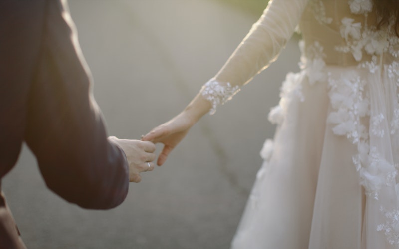 bride and groom hand holding on the move The Groom