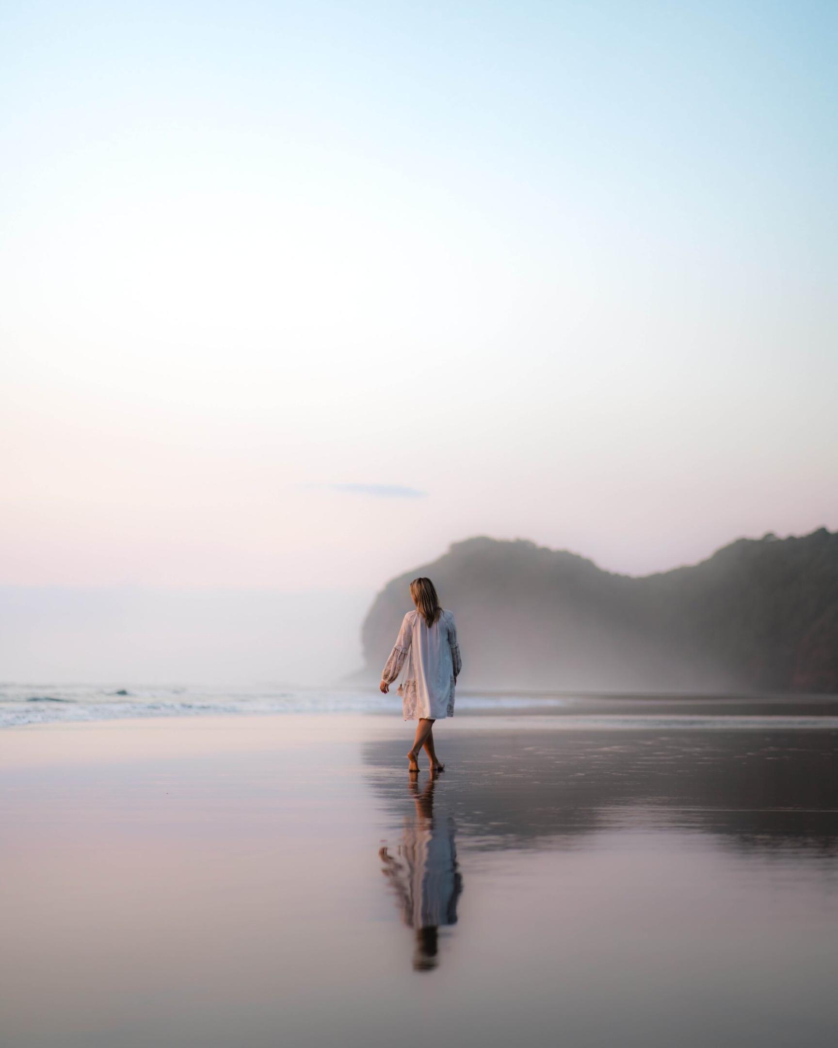 Woman alone on beach/wet sand with cliffs in the background It's Always Been You Blog Post