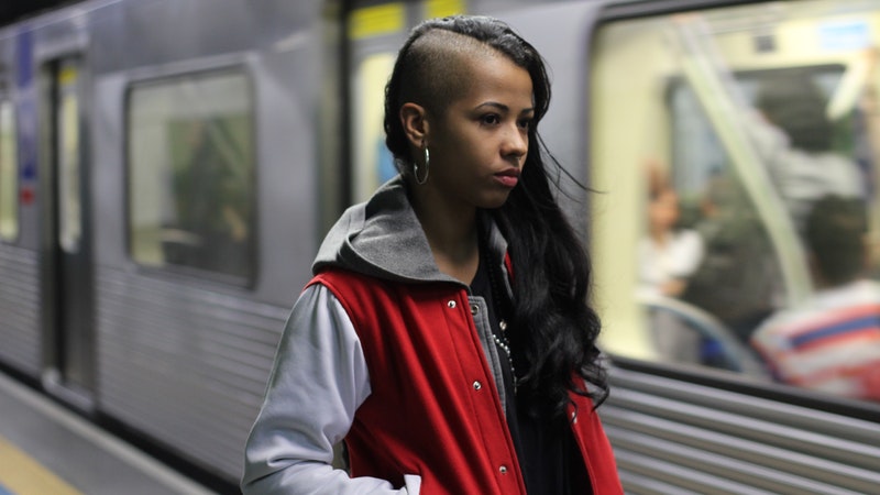 female in subway, train passing