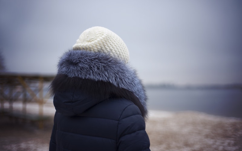 winter beach, back of woman winter coat and hat