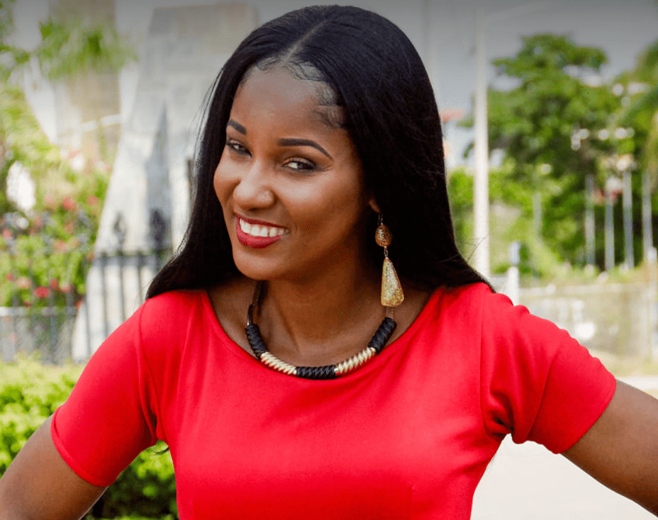 Headshot for Beverly Walters from Kingston, Jamaica. She's wearing a red top, long dangling gold earrings and a complimentary necklace. Surviving Human Trafficking