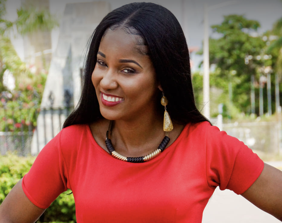 Headshot for Beverly Walters from Kingston, Jamaica. She's wearing a red top, long dangling gold earrings and a complimentary necklace. Surviving Human Trafficking